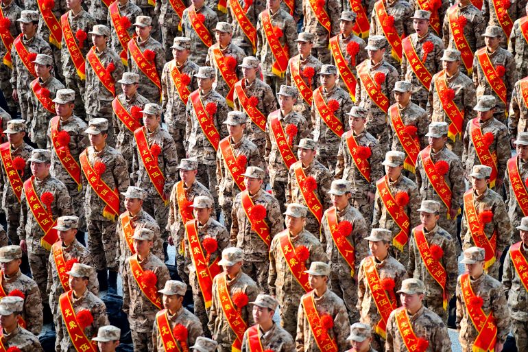 New recruits of Chinese People's Liberation Army (PLA) attend a send-off ceremony at a railway station in Ganzhou